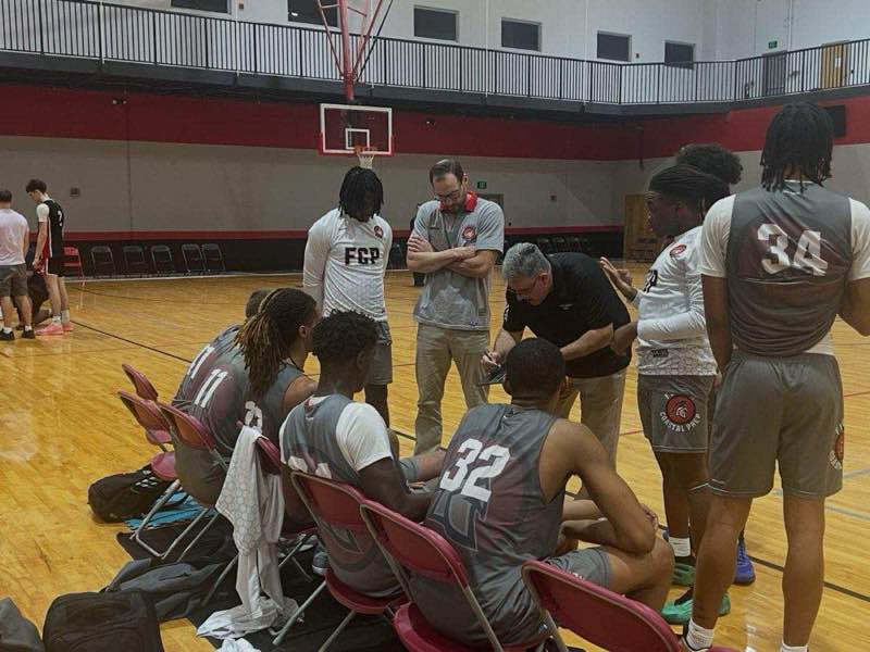 FCP Sports coaches drawing plays at halftime — basketball strategy session Fort Walton Beach